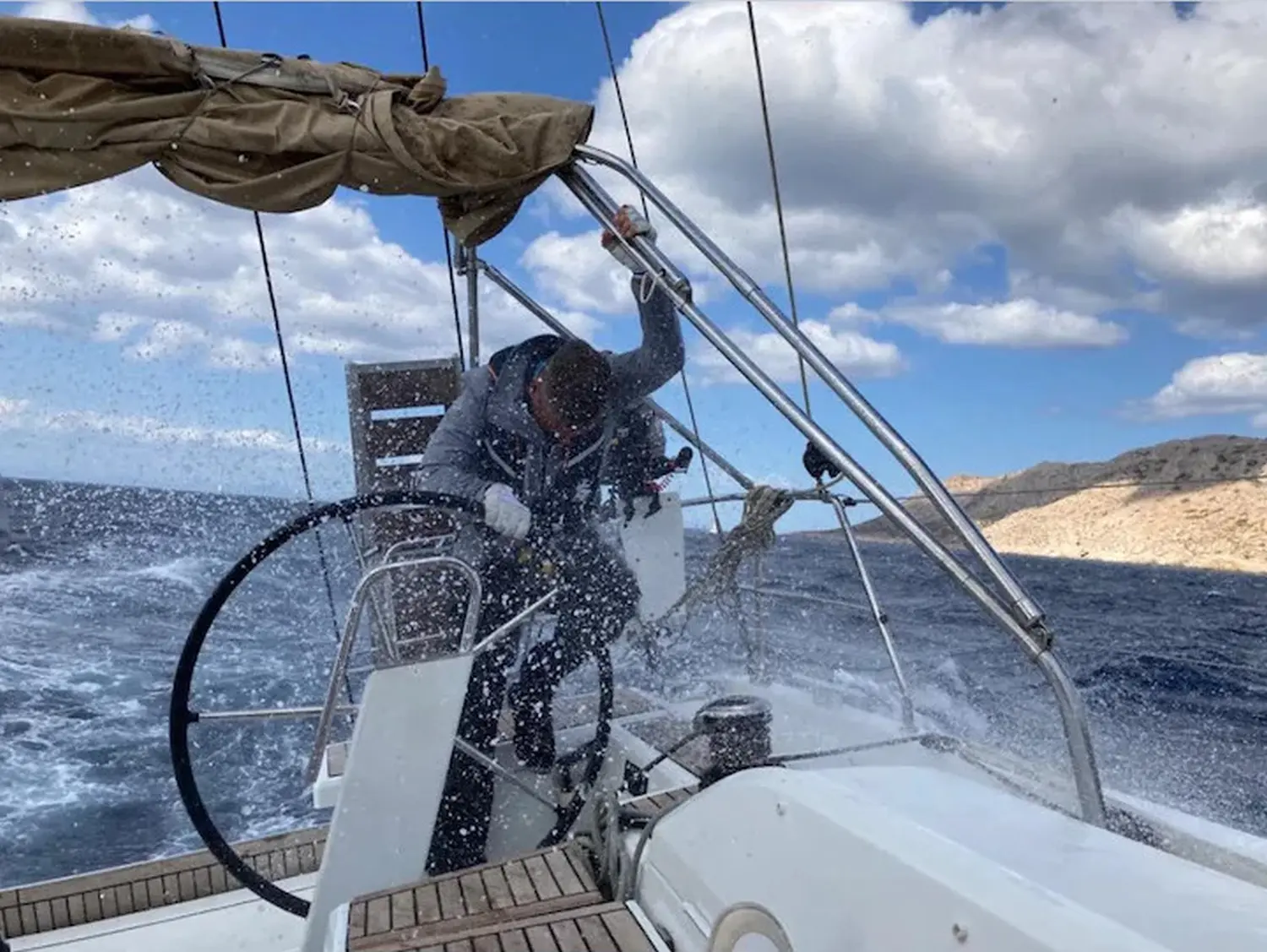 Successful Sailing - Skipper Thomas Lindloff sailing in the sea Water splashes on boat
